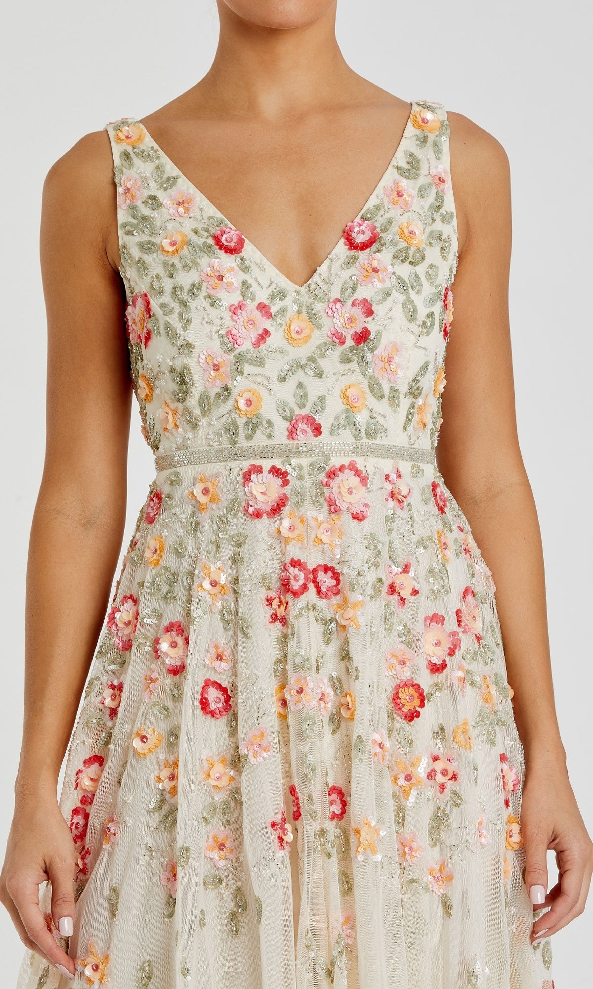 A woman wears the Mac Duggal 5527 Floral-Embroidered Party Dress, a sleeveless V-neck tea-length dress with a fitted bodice and red, pink, orange, and green floral embroidery on sheer light fabric—ideal for special occasions.
